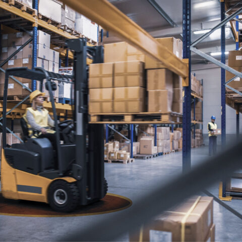 Motion blur captures the dynamic action of a forklift operator maneuvering in a warehouse, with the safety of Troax Active Safety